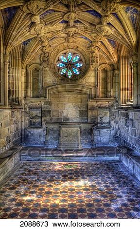 Stock Image - Interior of an historic building with ornate ceiling and stained glass window in the shape of a flower. Fotosearch