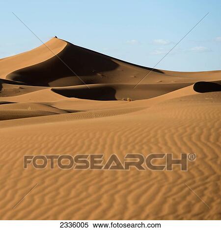 Landscape of drifted sand slopes against a blue sky View Large Photo Image Stock Photography - Landscape of drifted sand slopes against a blue sky. Fotosearch