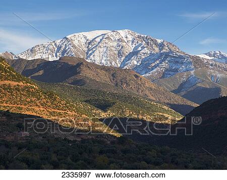 Landscape of mountains and hills with a blue sky View Large Photo Image Stock Photo - Landscape of mountains and hills with a blue sky. Fotosearch