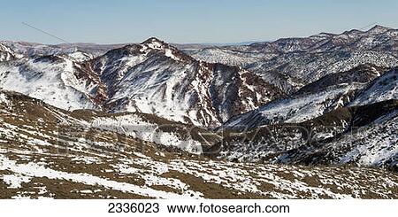 Stock Image - Landscape of mountains with snow and a blue sky. Fotosearch