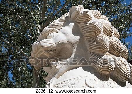 Low angle view of a statue of a lion with a tree and blue sky; China View Large Photo Image Stock Image - Low angle view of a statue of a lion with a tree and blue sky; China. Fotosearch