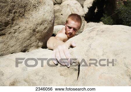 Stock Photograph - Man rock climbing (bouldering) at Lizard's Mouth; Santa Barbara, California, United States of America. Fotosearch