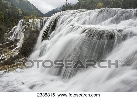 Motion blur of water flowing over cliffs in the mountains View Large Photo Image Stock Photography - Motion blur of water flowing over cliffs in the mountains. Fotosearch
