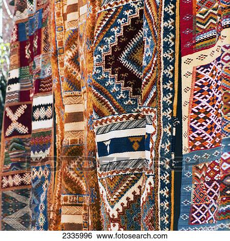 Multi-coloured textiles hanging on display View Large Photo Image Stock Photograph - Multi-coloured textiles hanging on display. Fotosearch
