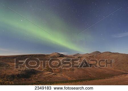 Stock Image - Northern Lights above Eagle Summit and Pinelle Mountain Range along the Steese Highway, North of Fairbanks; Alaska, United States of America. Fotosearch