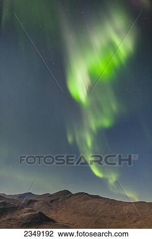 Stock Image - Northern Lights above Eagle Summit and Pinelle Mountain Range along the Steese Highway, North of Fairbanks; Alaska, United States of America. Fotosearch