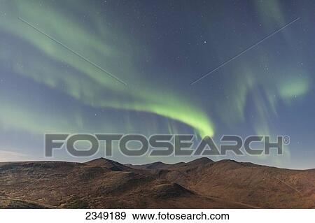 Stock Photo - Northern Lights above Eagle Summit and Pinelle Mountain Range along the Steese Highway, North of Fairbanks; Alaska, United States of America. Fotosearch