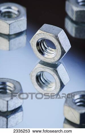 Stock Image - Nuts on a reflective surface. Fotosearch