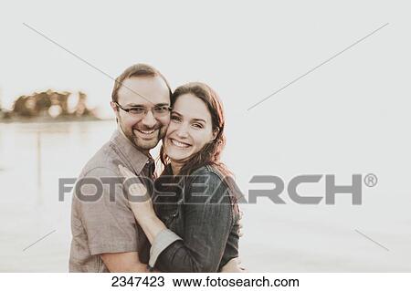 Stock Image - Portrait of a couple in an embrace; Crescent Beach, British Columbia, Canada. Fotosearch