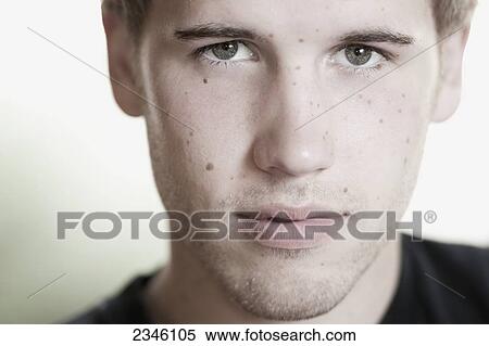 Stock Photography - Portrait of a young man with freckles; California, United States of America. Fotosearch