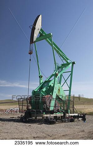 Stock Photography - Pumpjack against a blue sky; Longview, Alberta, Canada. Fotosearch