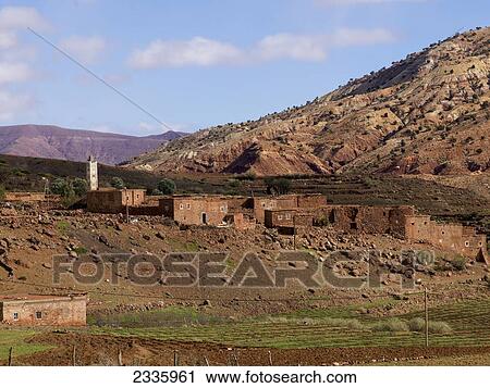 Residential buildings built on a hill with mountains in the background View Large Photo Image Stock Image - Residential buildings built on a hill with mountains in the background. Fotosearch