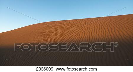 Stock Photo - Ripples in the sand and a blue sky. Fotosearch