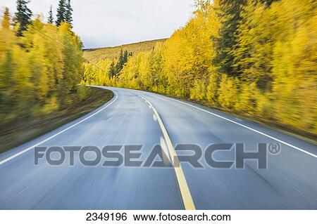 Stock Photograph - Road detail traveling the Steese Highway North of Fairbanks in autumn; Fairbanks, Alaska, United States of America. Fotosearch