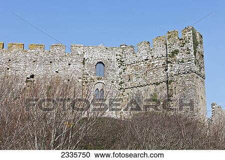 Stock Image - Ruins of a stone wall against a blue sky. Fotosearch