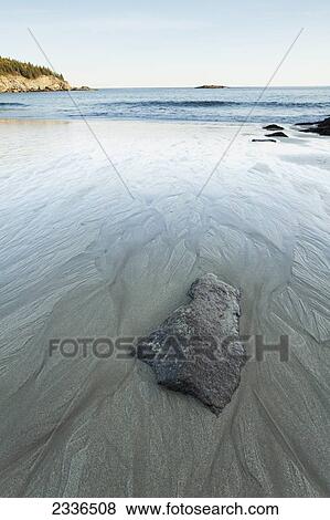 Stock Photo - Sandy beach with water trails, Acadia National Park; Maine, United States of America . Fotosearch