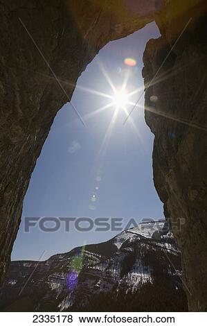 Silhouette of cave entrance with sun burst and blue sky; Bragg Creek, Alberta, Canada View Large Photo Image Stock Photo - Silhouette of cave entrance with sun burst and blue sky; Bragg Creek, Alberta, Canada. Fotosearch