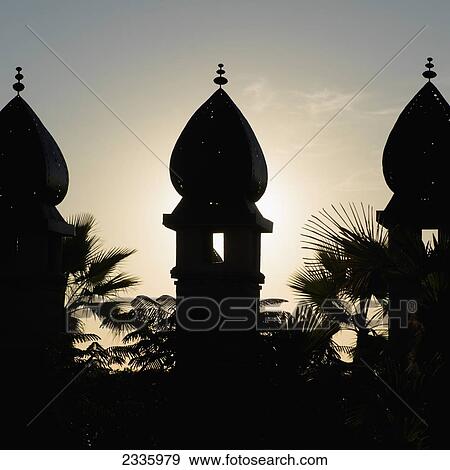 Silhouette of three turrets and palm trees at sunset View Large Photo Image Stock Photo - Silhouette of three turrets and palm trees at sunset. Fotosearch
