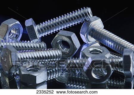 Stock Image - Silver screws and bolts on a black background. Fotosearch