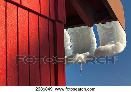 Snow melting and sliding off a rooftop in the shape of the eaves View Large Photo Image Stock Photo - Snow melting and sliding off a rooftop in the shape of the eaves. Fotosearch