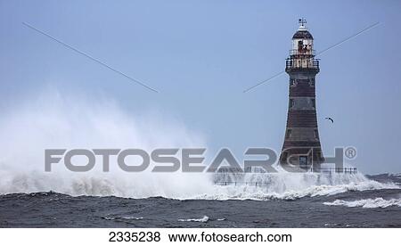 Splashing water from a crashing wave against a lighthouse; Sunderland, Tyne and Wear, England View Large Photo Image Stock Photo - Splashing water from a crashing wave against a lighthouse; Sunderland, Tyne and Wear, England. Fotosearch