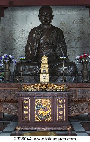 Statue of Buddha with flowers at a shrine View Large Photo Image Picture - Statue of Buddha with flowers at a shrine. Fotosearch