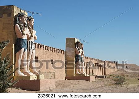 Statues of Egyptian male figures along a wall and a blue sky View Large Photo Image Stock Image - Statues of Egyptian male figures along a wall and a blue sky. Fotosearch