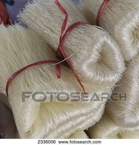 Strands of a white fibre tied with red string in bundles View Large Photo Image Stock Photograph - Strands of a white fibre tied with red string in bundles. Fotosearch