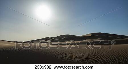 Sunlight over a hilly sand landscape View Large Photo Image Stock Image - Sunlight over a hilly sand landscape. Fotosearch