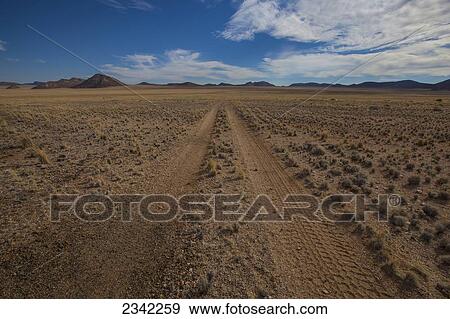 Stock Photo - Tire tracks in the dirt on a desert road; Klein-Aus Vista, Namibia. Fotosearch