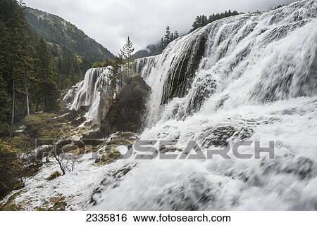 Stock Photograph - Water rushing over cliffs in the mountains. Fotosearch