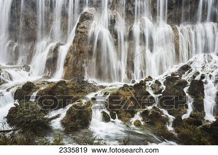 Stock Photo - Waterfalls splashing and streaming over rocks. Fotosearch