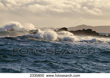 Waves crashing against the rocky shoreline View Large Photo Image Stock Image - Waves crashing against the rocky shoreline. Fotosearch