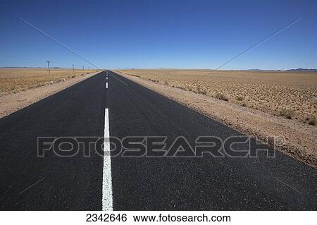 Stock Photograph - White line on a paved road in the desert; Garub, Namibia. Fotosearch