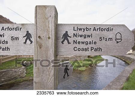 Stock Image - Wooden sign and post for Wales Coast Path; Wales. Fotosearch