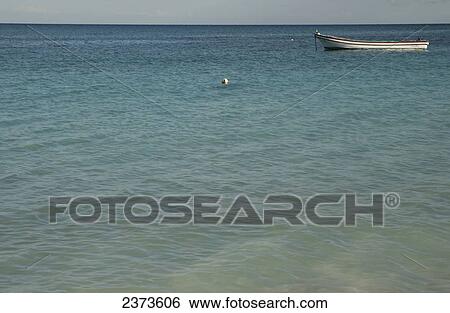 Stock Photograph - A fishing boat in the water; Tulum, Mexico. Fotosearch