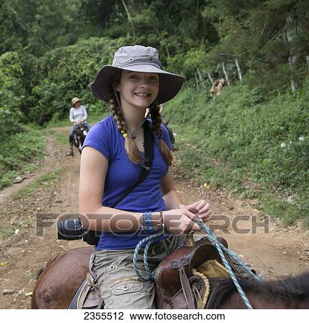 A Girl Riding A Horse On A Trail; Finca El Cisne, Honduras View Large Photo Image Stock Image - A Girl Riding A Horse On A Trail; Finca El Cisne, Honduras. Fotosearch