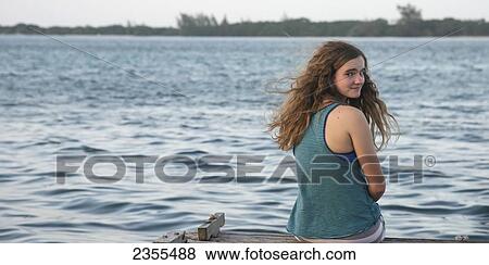 A Girl Sits On The Edge Of A Dock; Utila, Bay Islands, Honduras View Large Photo Image Stock Photo - A Girl Sits On The Edge Of A Dock; Utila, Bay Islands, Honduras. Fotosearch