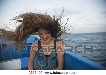 Stock Image - A Girl's Long Hair Whipping Through The Air On A Boat Ride; Utila, Bay Islands, Honduras. Fotosearch