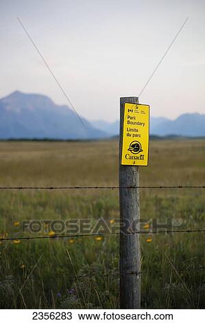 Stock Image - A Parks Canada Sign For A Park Boundary In Waterton Lakes National Park; Alberta, Canada. Fotosearch