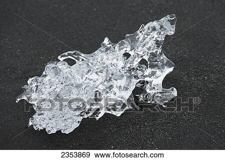 A Piece Of Ice On Black Sand At A Glacial Lagoon; Jokulsarlon, Austur-Skaftrafellssysla, Iceland View Large Photo Image Stock Photo - A Piece Of Ice On Black Sand At A Glacial Lagoon; Jokulsarlon, Austur-Skaftrafellssysla, Iceland. Fotosearch