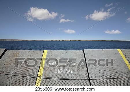 Stock Photograph - A Ramp At The Water's Edge With A Sign To Wait For Signal; Saskatchewan, Canada. Fotosearch