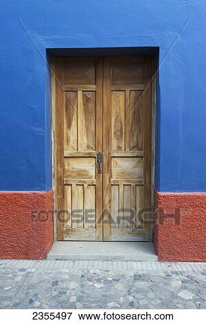 A Weathered Wooden Door Set Inside A Doorway Painted Blue And Red; Copan, Honduras View Large Photo Image Stock Photo - A Weathered Wooden Door Set Inside A Doorway Painted Blue And Red; Copan, Honduras. Fotosearch