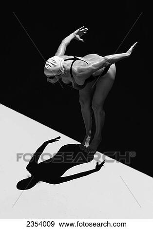 A Woman Prepares To Jump Backwards Off The Edge Of A Pool Into The Water; Tarifa, Cadiz, Andalusia, Spain View Large Photo Image Stock Photo - A Woman Prepares To Jump Backwards Off The Edge Of A Pool Into The Water; Tarifa, Cadiz, Andalusia, Spain. Fotosearch