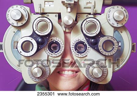 A Woman Sitting Behind Optometry Equipment In An Eye Examination; Tarifa, Cadiz, Andalusia, Spain View Large Photo Image Stock Image - A Woman Sitting Behind Optometry Equipment In An Eye Examination; Tarifa, Cadiz, Andalusia, Spain. Fotosearch