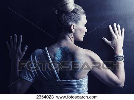A Woman With Hands Against A Wall And A Large Tattoo On Her Back; Tarifa, Cadiz, Andalusia, Spain View Large Photo Image Stock Image - A Woman With Hands Against A Wall And A Large Tattoo On Her Back; Tarifa, Cadiz, Andalusia, Spain. Fotosearch
