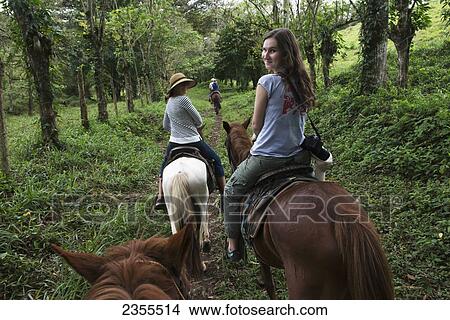 A Young Woman And Her Mother Riding Horses On A Trail; Zacapa, Guatemala View Large Photo Image Picture - A Young Woman And Her Mother Riding Horses On A Trail; Zacapa, Guatemala. Fotosearch