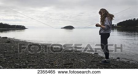 A Young Woman Stands On A Rocky Beach In Deception Pass State Park; Oak Harbor, Washington, United States Of America View Large Photo Image Stock Photography - A Young Woman Stands On A Rocky Beach In Deception Pass State Park; Oak Harbor, Washington, United States Of America. Fotosearch