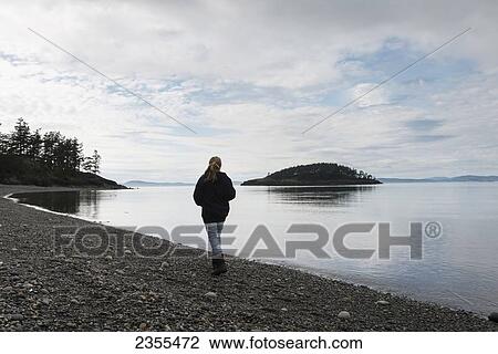 A Young Woman Walks On A Rocky Beach In Deception Pass State Park; Oak Harbor, Washington, United States Of America View Large Photo Image Stock Image - A Young Woman Walks On A Rocky Beach In Deception Pass State Park; Oak Harbor, Washington, United States Of America. Fotosearch