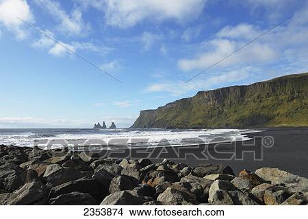 Black Lava Beach With Basalt Stacks Of Reynisdrangar In The Background; Vik, Vestur-Skaftafellssysla, Iceland View Large Photo Image Picture - Black Lava Beach With Basalt Stacks Of Reynisdrangar In The Background; Vik, Vestur-Skaftafellssysla, Iceland. Fotosearch